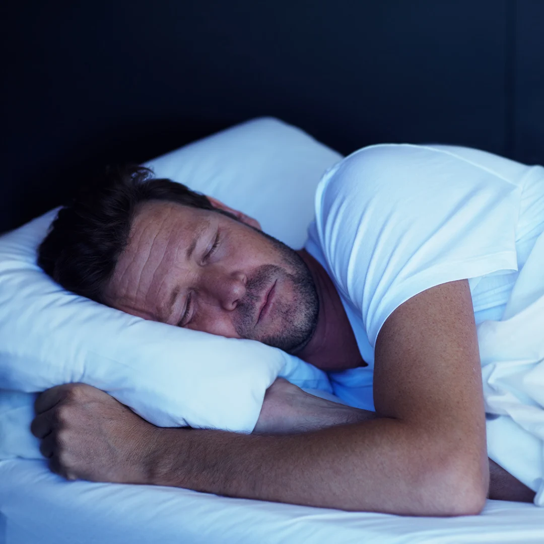 Person sleeping peacefully in bed